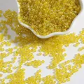 Translucent yellow glass seed beads for DIY bracelets in a white ceramic dish - Yellow