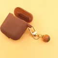 Brown silicone case for AirPods with bubble tea charm and golden carabiner clip - Milk Tea Ball Style