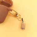 Brown silicone earphone case featuring a creative bubble tea pendant and golden carabiner - Milk Tea Cup Style