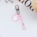Close-up of cute pink gummy bear keychain with glitter acrylic charms and metal clasp - Pink