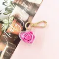 Pink preserved rose heart keychain with golden clip and transparent acrylic shell - Rose Red