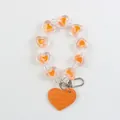 Macro detail of beaded heart keychain with orange leather heart and silver lobster clasp - Orange (a5059-7)
