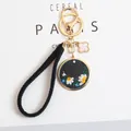 Detail of embroidered daisy keychain with gold lobster clasp and black leather pendant - Small Daisy Round Plate (a5076-3) / Black