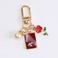 Golden alloy keychain with red rose, pearl, and enamel rectangle charm on white background - Pearl Rose Rectangle Style (a5036-2)