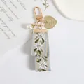 Macro detail of embroidered floral ribbon keychain with golden heart charm and pearl - Heart Charm Floral Ribbon Style (a5095-3)