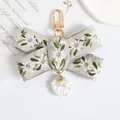 Detail of embroidered floral bow keychain with pearl and shell pendants and gold clasp - Shell Pendant Embroidered Bow Style (a5095-4)