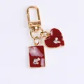 Golden keychain with heart and rectangle charms in deep red enamel and rhinestones - Double Red Pendant Style (a5036-4)