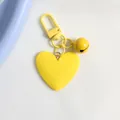 Close-up of bright yellow heart-shaped keychain with matching metal bell and clasp - Bright Yellow (a5098-7)
