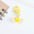 Macro detail of bright yellow heart pendant with matching decorative lobster clasp - Yellow