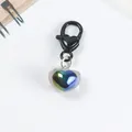 Macro detail of iridescent heart pendant with black spring clasp on white background - Black