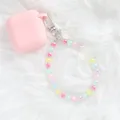 Close-up of pink silicone earbud case with colorful crystal flower beaded wristlet strap - Pink (5144-2)