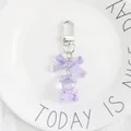 Detail of cute purple resin bear keychain with bow and silver metal clip closure - Purple