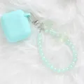 Close-up of mint green headphone case with translucent rose beads on white fur - Mint Green (5144-6)