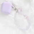 Detail of lavender silicone AirPods case with floral bead keychain on faux fur background - Light Purple (5144-1)
