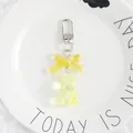 Detailed view of yellow translucent resin bear keychain with bow and silver metal clasp - Yellow