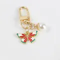 Golden butterfly keychain with red enamel wings and a white pearl pendant decoration - Red White Green Butterfly (5111-3)