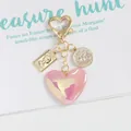 Detail of pink aurora heart charm and vintage queen relief coin keychain pendant - Phantom Purple