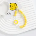 Detailed close-up of yellow beaded phone charm with acrylic heart pendant and flower beads - Bright Yellow (5167-4)