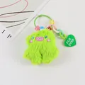 Close-up of neon green monster plush keychain with colorful beads and heart charm - Fluorescent Green