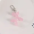 Detailed close-up of a pink resin balloon dog pendant with silver metallic spring clasp - Pink