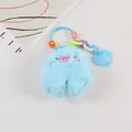 Blue plush monster keychain with embroidered face and heart pendant detail - Blue