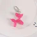 Detailed view of pink jelly resin balloon dog keychain in a white decorative dish - Rose Red