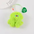 Detail of neon green plush monster keychain with smiling beads and For Ever heart tag - Neon Green