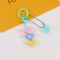 Detailed view of colorful 3D heart charms keychain with brand engraved heart tag - Yellow Blue Pink Multicolor (5187-2)