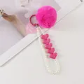 Detail view of pink fluffy faux fur pompom keychain with heart charm and pearl wristlet - Rose Pink (8196-5)