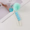 Detail of mint green faux fur pompom and light blue heart tag on a pearl keychain - Mint Green (8196-6)