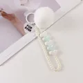 Detail of plush fur ball keychain with imitation pearls and heart charms on white background - White (8196-2)