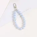 Close-up of light blue acrylic beads with clear outer shell and silver spring clasp - Light Blue
