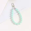 Detail of mint green acrylic beads with silver metal clasp on a decorative display card - Mint Green