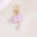 Close-up of iridescent lavender cloud keychain with a white drop pearl and golden clasp - Lavender (5200-2)
