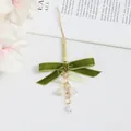 Detailed shot of olive green velvet bow with lily of the valley flowers and pearl accents - Long Ribbon Lily Of The Valley Style (5208-1)