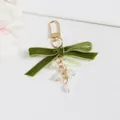 Detail of green velvet bow keychain with white lily of the valley flowers and pearl drop - D-Buckle Lily Of The Valley Style (5208-2)