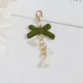 Detail of dark green velvet bow keychain with delicate white lily of the valley flowers - Lobster Clasp Lily Of The Valley Style (5208-3)