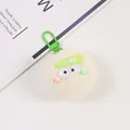 Close-up of a fluffy cream plush keychain featuring big eyes and a green metal clasp - Off-white