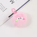 Close-up of a pink plush pompom keychain with cute eyes and plastic D-ring hook - Pink