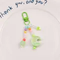 Close-up of pastel beaded keychain with green crescent moon and heart pendant on white plate - Light Green (yc5230-4)