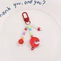 Macro detail of colorful resin beads and gradient moon pendant on a beaded keychain - Red (yc5230-7)