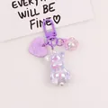 Detailed close-up of a holographic purple bear charm with white pearls and flower - Phantom Purple