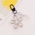 Macro shot of iridescent acrylic flower keychain with a matte black metal lobster clasp - Black (yc5231-5)