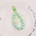 Detail of mint green beaded keychain with pearl-finish beads and cute bear pendant - Mint Green