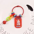 Close-up of red Fortune Cat Rabbit keychain with colorful beads and bell on ceramic plate - Wealth Gathering Rabbit (yc5243-4)