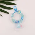 Close-up of blue beaded keychain with letter E charm and miniature milk tea cup pendant - Blue (E)