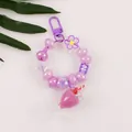 Detail of purple milk tea cup keychain with beads and an 'N' letter charm - Purple (N)