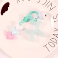 Detailed macro view of a translucent cyan balloon dog charm with heart beads and bell - Blue (yc5257)