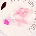 Detail of pink jelly balloon dog keychain with heart charms on a white decorative plate - Pink (yc5257)