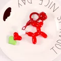 Detail of red balloon dog keychain featuring a metal ring, small bell, and colorful heart charms - Red (yc5257)